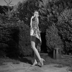 Estella Rose in purple swimsuit exercising in the garden