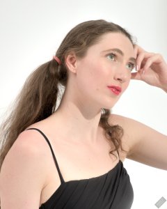2026-08-01 Estella Rose models black one-piece swimsuit and accessories..