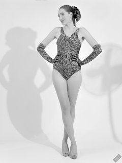 2026-08-01 Estella Rose models vintage animal-print one-piece swimsuit.