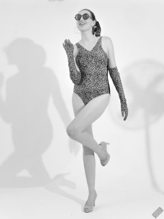 2026-08-01 Estella Rose models vintage animal-print one-piece swimsuit.