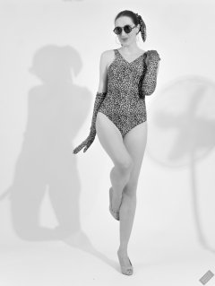 2026-08-01 Estella Rose models vintage animal-print one-piece swimsuit.
