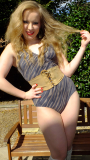 Sunshine girl KVV (Kristina) poses in the garden, modelling vintage M&S tummy-control swimsuit and tight corset belt to nip in her waist