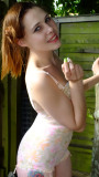 Lora in Berlei corselette enjoys a break in the garden