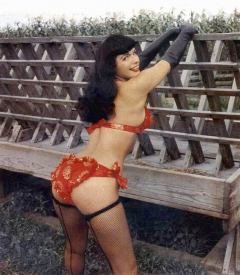 Bettie Page posing in red and gold swimsuit