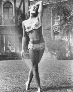 Shirley Eaton in bikini playing with sprinkler