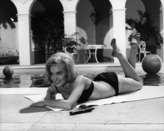 Shirley Eaton sunbathing in black bikini